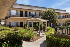 Santee apartment for rent - A building with a balcony and a gazebo in the front yard.