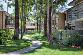 Lake Forest apartment for rent - A pathway in a park with trees on either side.