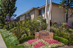 Lake Forest apartment for rent - A sign that says "The Timbers Apartments" is in front of a building.