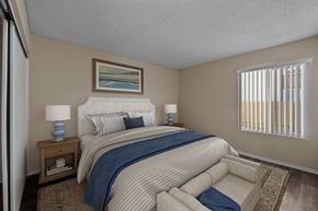 Camarillo apartment for rent - A bedroom with a large bed and a painting on the wall.