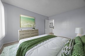 Oceanside apartment for rent - A bedroom with a bed, dresser, and a painting on the wall.