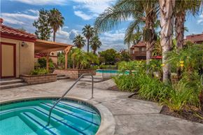 Redlands apartment for rent - A pool with a slide in the middle of a backyard.