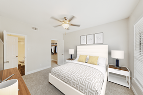 Houston apartment for rent - A bedroom with a large bed and a ceiling fan.