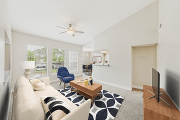Houston apartment for rent - A living room with a white couch and a blue chair.