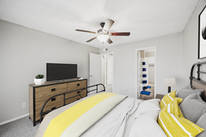 Bedford apartment for rent - A bedroom with a bed, a dresser, and a ceiling fan.