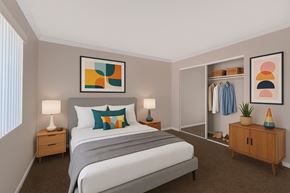 Garden Grove apartment for rent - A bedroom with a large bed, two nightstands, a side table, sliding closet mirror doors, and a couple of paintings on the walls.
