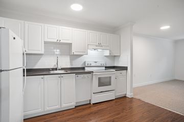 Vancouver apartment for rent - A kitchen with white cabinets and appliances.