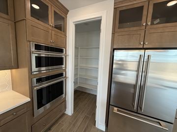 Chandler house for rent - A kitchen with wooden cabinets and a stainless steel refrigerator.