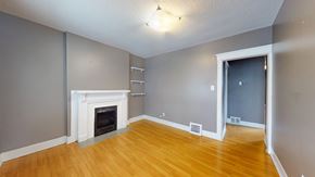 Toronto apartment for rent - A room with a fireplace and wooden floors.