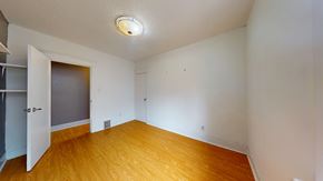 Toronto apartment for rent - A room with a wooden floor and a ceiling light.