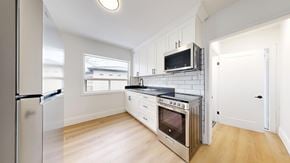 Toronto apartment for rent - A kitchen with a refrigerator, oven, and microwave.