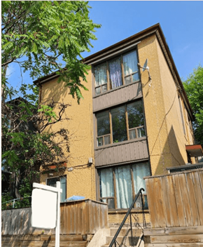Toronto apartment for rent - A brown building with a white door and windows.