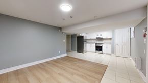 Toronto apartment for rent - A kitchen area with a refrigerator, oven, and microwave.