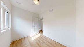 Toronto apartment for rent - A room with a wooden floor and white walls.