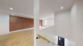 Toronto apartment for rent - A room with a brick wall and wooden flooring.