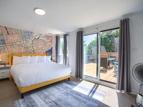 Toronto apartment for rent - A bedroom with a large bed and a map on the wall.