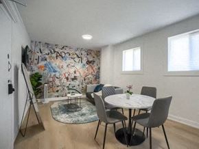 Toronto apartment for rent - A dining room with a white table and chairs.