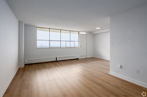 Toronto apartment for rent - A room with wooden flooring and a window with a view of the outside.