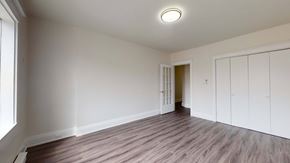 Toronto apartment for rent - A room with wooden flooring and white walls.
