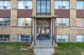 Toronto apartment for rent - The front of a building with a glass door and windows.
