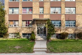 Toronto apartment for rent - A brick building with a glass door and windows.