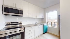 Toronto apartment for rent - A kitchen with white cabinets and a stainless steel oven.