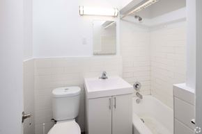 Toronto apartment for rent - A white toilet sits next to a sink in a small bathroom.
