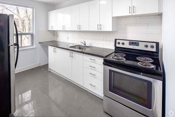Toronto apartment for rent - A modern kitchen with a stove and a refrigerator.