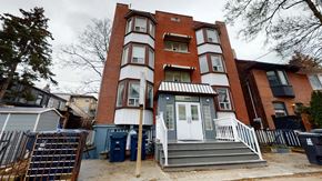 Toronto apartment for rent - A red brick building with a white door and windows.