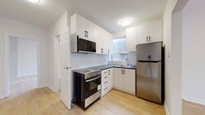Toronto apartment for rent - A kitchen with a stove, oven, refrigerator, and microwave.