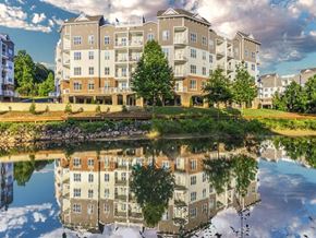 Mooresville apartment for rent - A large building with a pond in front of it.