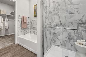 Mooresville apartment for rent - A bathroom with a marble tile wall and a white toilet.