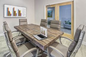 Mooresville apartment for rent - A conference room with a table, chairs, and a chart on the wall.