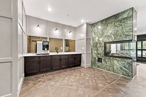 Mahtomedi apartment for rent - A kitchen with a marble backsplash and dark wood cabinets.
