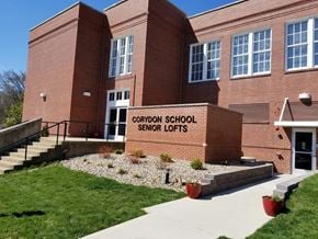 Corydon apartment for rent - a large brick school building with a sign that reads cardinal school secret lofts