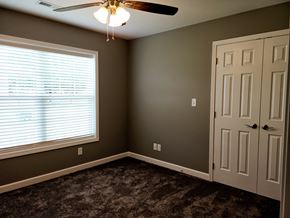 Vincennes apartment for rent - a bedroom with a ceiling fan and a window and a door