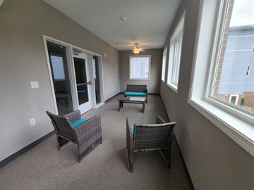 Kokomo apartment for rent - a living room with two chairs and a table and two windows