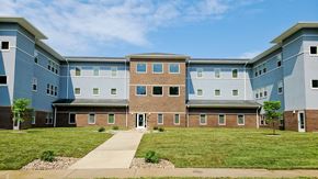 Kokomo apartment for rent - an exterior view of an apartment building with a green lawn