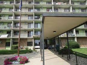 Kokomo apartment for rent - the front of an apartment building with a porch and a flag