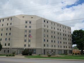 Evansville apartment for rent - a large stone building with an flag in front of it