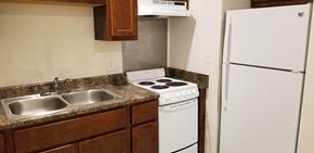 Evansville apartment for rent - a kitchen with white appliances and a sink and a refrigerator