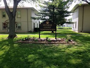 Kokomo apartment for rent - a sign in the grass in front of a building
