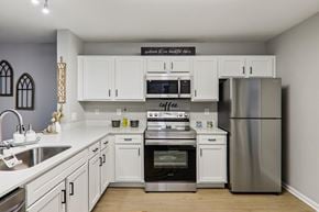 Spartanburg apartment for rent - Apartment kitchen with white cabinetry and stainless steel appliances in Spartanburg, SC