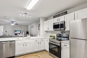 Spartanburg apartment for rent - A modern kitchen with white cabinets and stainless steel appliances.