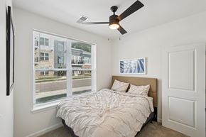Fortville apartment for rent - A bedroom with a large bed and a ceiling fan.