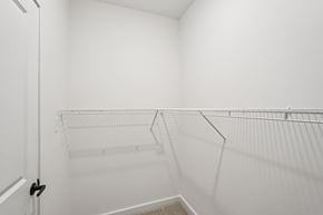 Fortville apartment for rent - A white closet with a metal rod for hanging clothes.