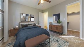 Fortville apartment for rent - A bedroom with a bed, a ceiling fan, and a rug at Ridgeview Apartments, Indiana