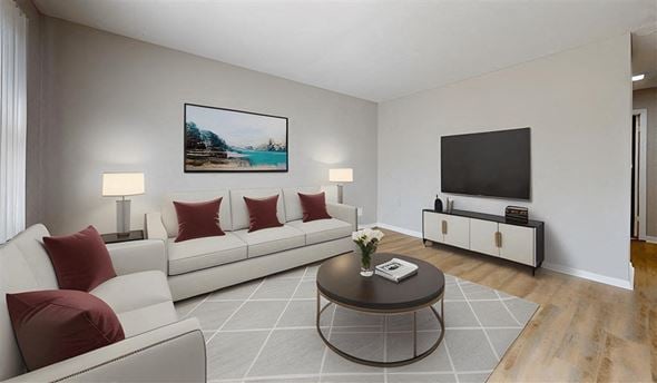 Franklin apartment for rent - A living room with a white couch, a coffee table, and a painting on the wall at Stonebrook of Franklin Apartments, Indiana, 46131