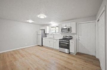 Indianapolis apartment for rent - A kitchen with white cabinets and stainless steel appliances.