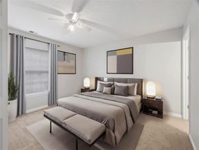 Lebanon apartment for rent - A bedroom with a large bed and a ceiling fan at Parkview of Lebanon Apartments, Lebanon, IN, 46052